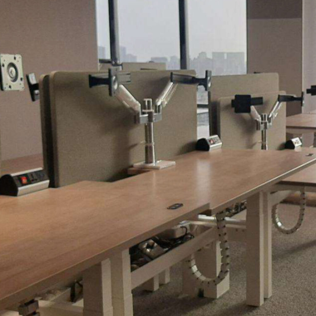 Row of empty service desks with partition panels in an office lobby or reception area.